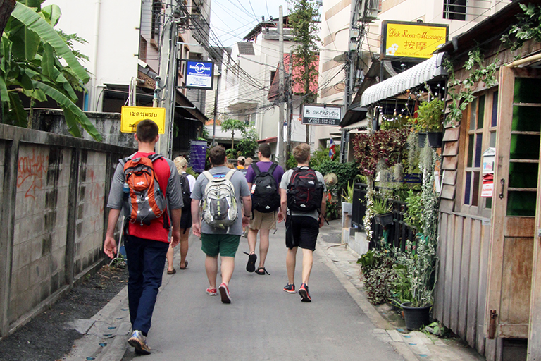 Tickle College of Engineering group walking on historic Tha Pae Street.