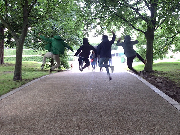 Students jumping in a park.