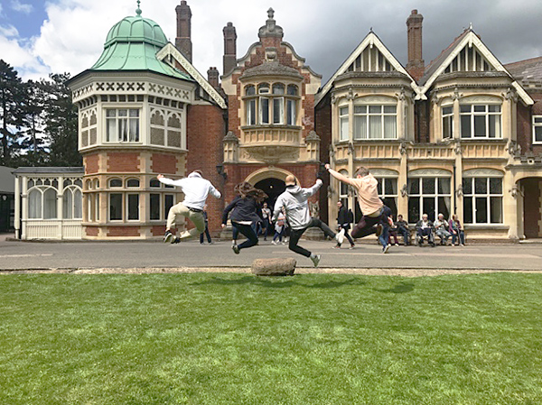 Students jumping in front of Bletchley Park.