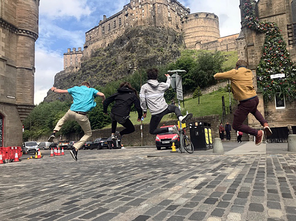 Students jumping in a street.