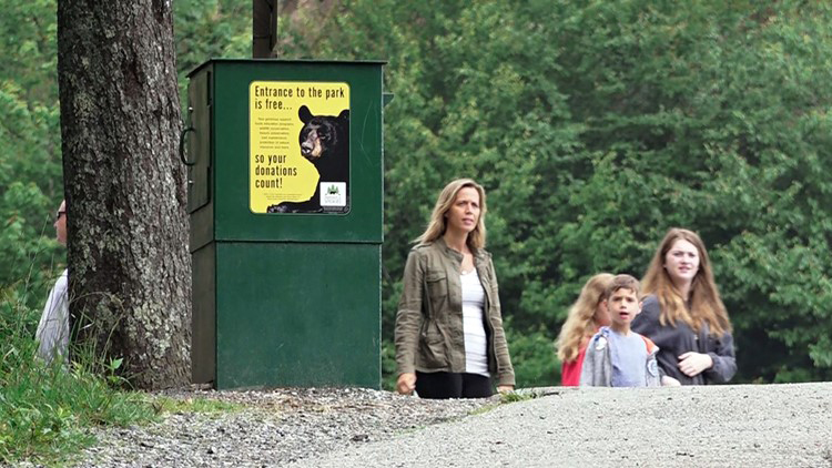 Visitors at Newfound Gap walk past a new donation box design in the Great Smoky Mountains National Park. Photo provided by WBIR.