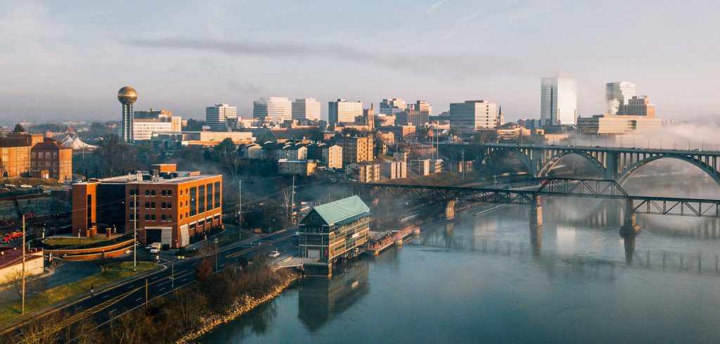 Aerial drone photo of the John D. Tickle Engineering Building, the Tennessee River, and downtown Knoxville during a foggy morning in February 2019