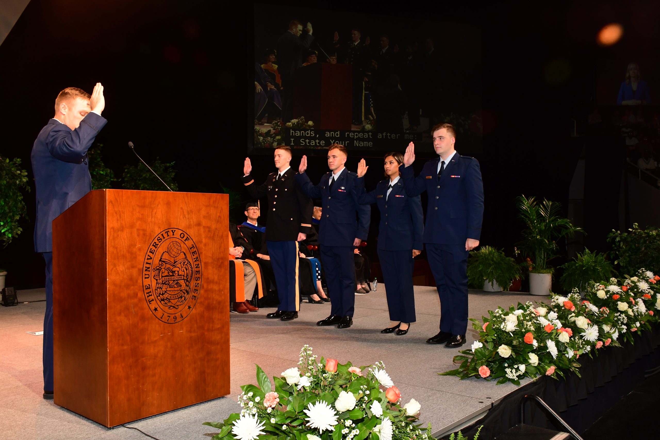Graduates from the Tickle College of Engineering are sworn in to the military during the commencement ceremony.