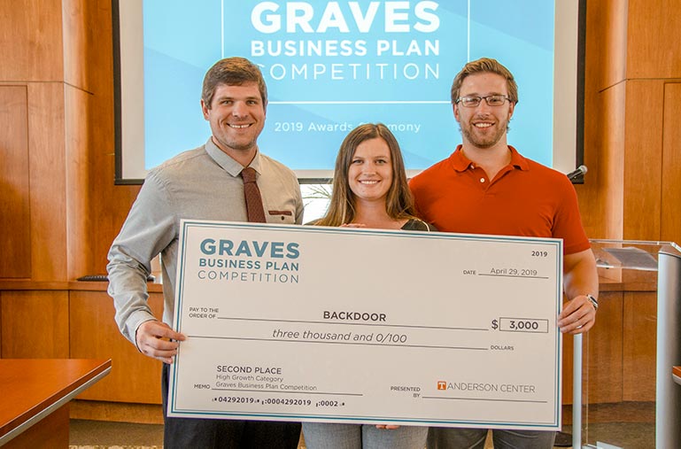 Alex Weber, Makenzie Swicegood, and Brad Bennett (from left to right) pose with their check from the Graves Business Plan Competition.