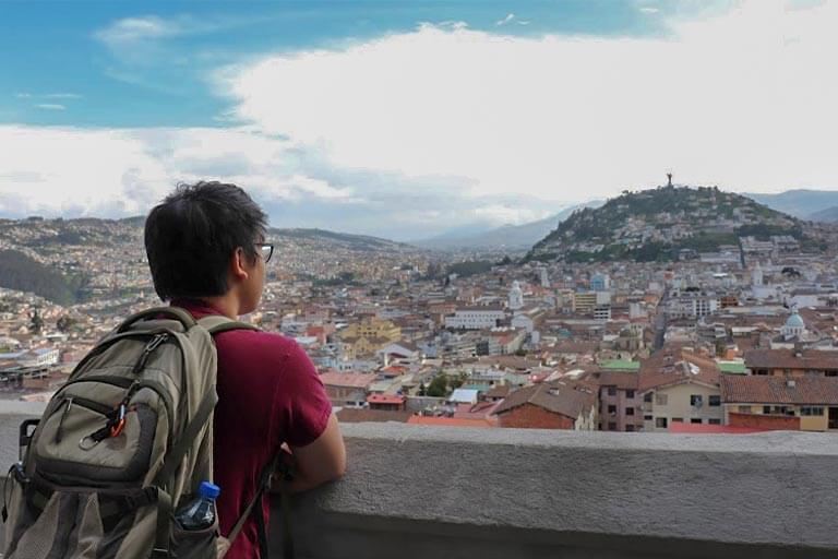 Phillip Chu Stands at an Overlook in Quito