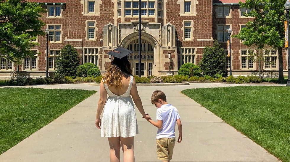 Jess Ossyra with her son, John in front of Ayres Hall