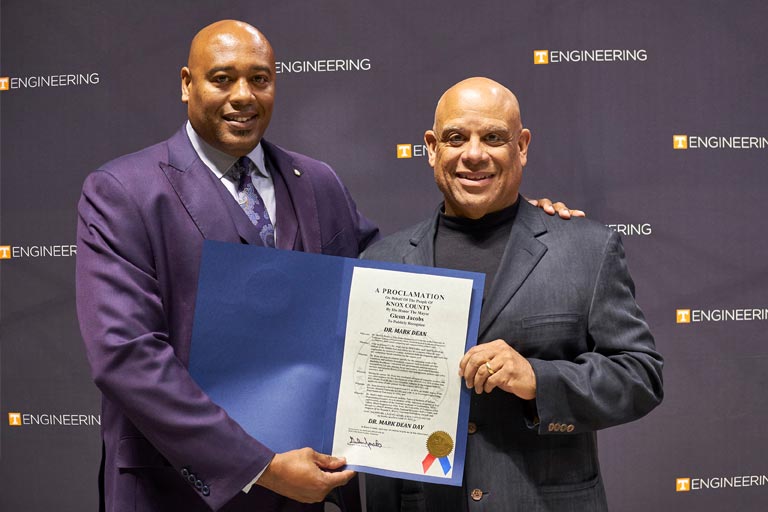 Darris Upton, Knox County’s Diversity Development Manager, left, presents Mark Dean with a proclamation making April 25 “Dr. Mark Dean Day.”