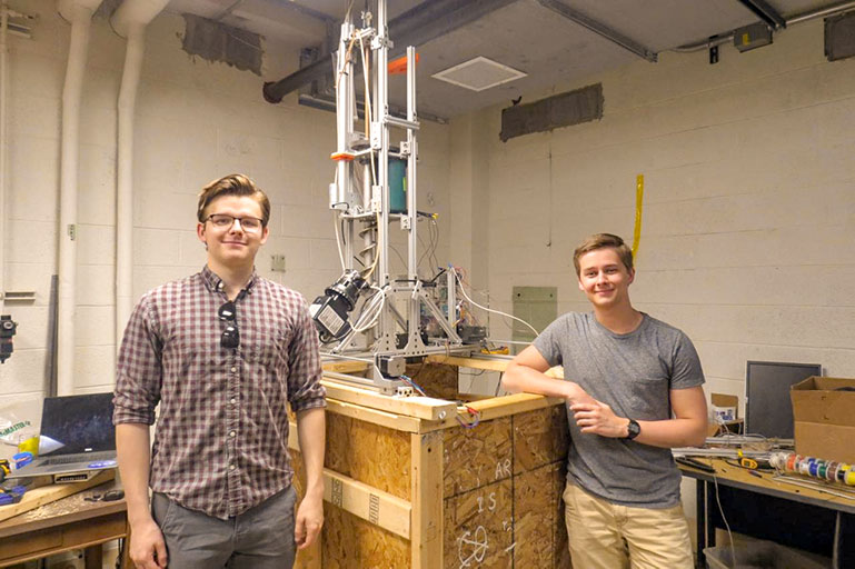 Brian Coulter, left, a senior from Tullahoma majoring in aerospace engineering, and Alex Twilla, a junior from Milan majoring in computer engineering, stand next to UT's entry in this year's Mars Ice Challenge.