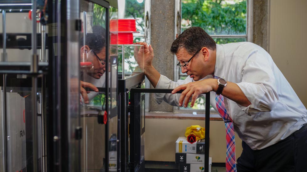 Matthew Mench checks on 3D Printer