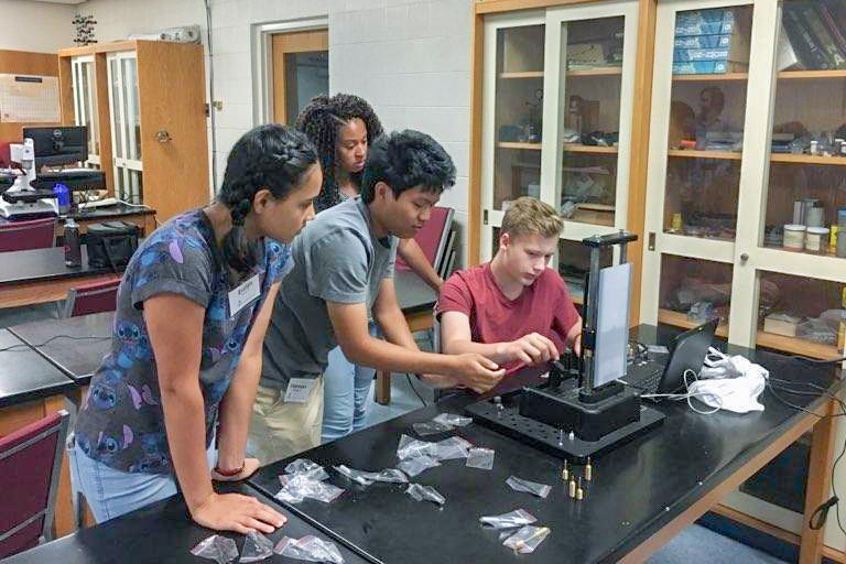 Students participating in the Materials Camp work on a project in a Ferris Hall lab.