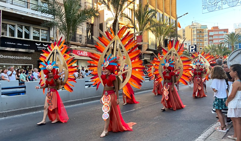 Several people dressed up and participating in a parade.