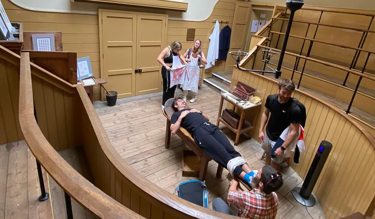 Several students explore the history of surgical operations at the Old Operating Theater.
