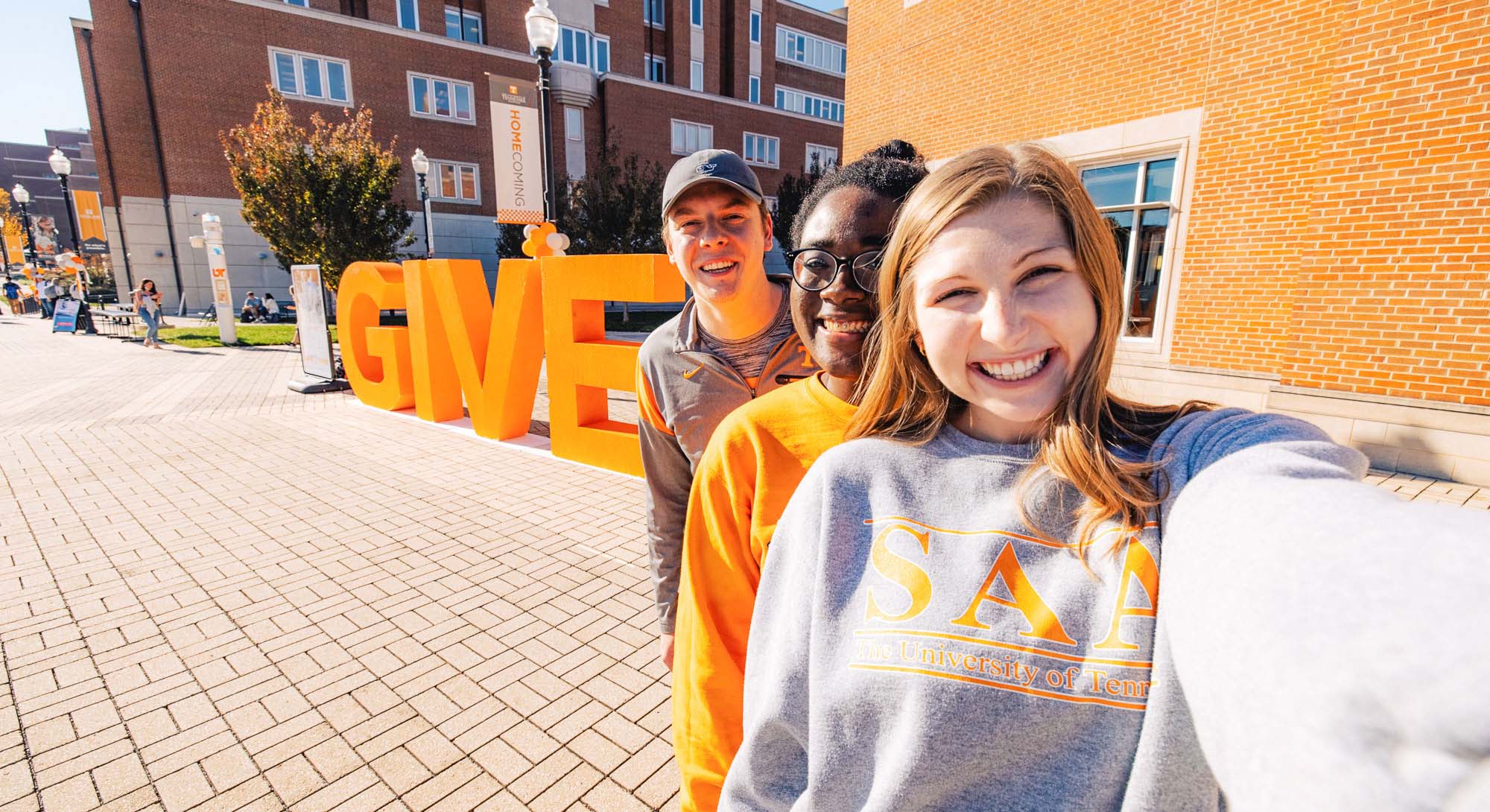Students standing in front of GIVE sign