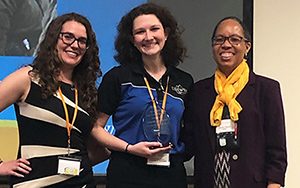 Amy Hill, Duke Energy and Region II Representative (left), and Mechelle Stanton, Institute of Nuclear Power Operators (right), presents Amanda Bachmann (center) with the US Women in Nuclear Region II Leadership Award.