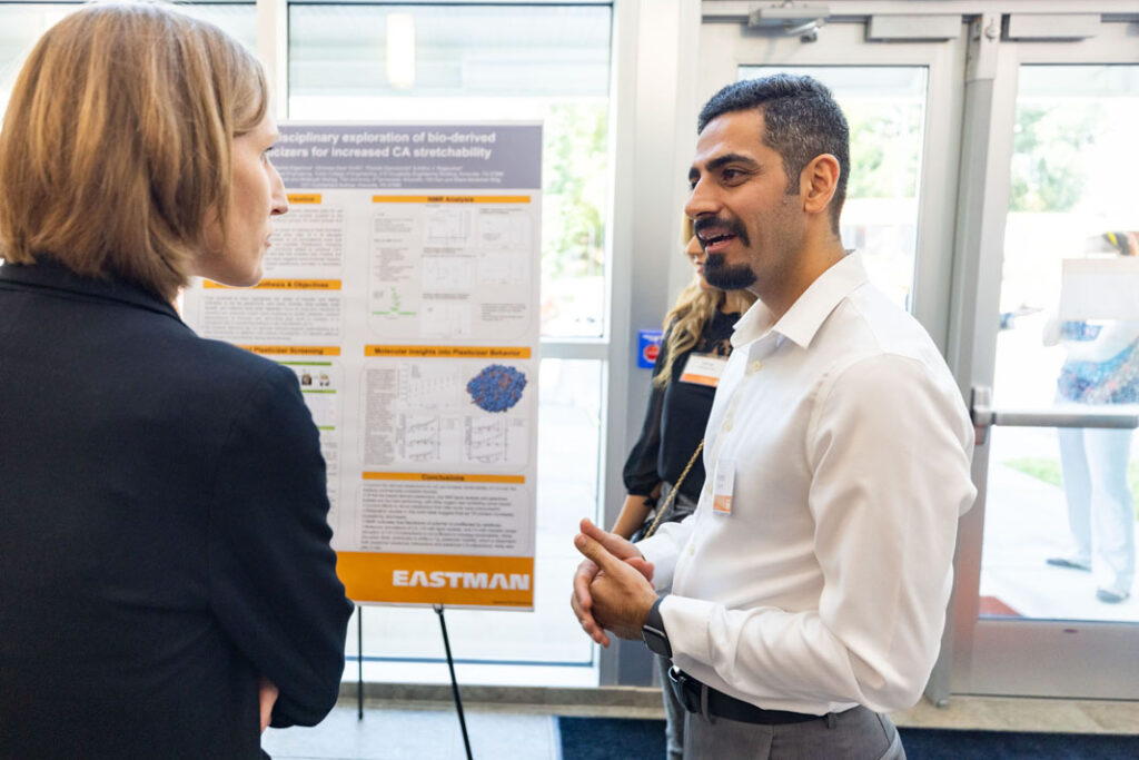 Guests talk during the research poster presentations following the ribbon cutting at the Eastman Innovation Center dedication on Thursday, August 25.