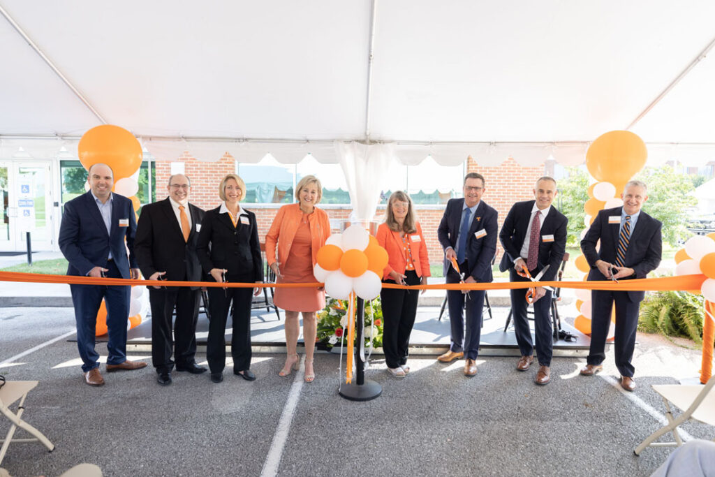 Leadership from Eastman and the University of Tennessee cut the ribbon—a high-tech, sustainably sourced material developed by Eastman— at the Eastman Innovation Center dedication on Thursday, August 25. From left to right: Brendan Abolins, Eastman external innovation manager; Scott Armentrout, Eastman director for applications and external innovation; Dawn Mason, Eastman global external innovation manager; Donde Plowman, UT chancellor; Deborah Crawford, UT vice chancellor for research, innovation, and economic development; Steve Crawford, Eastman executive vice president for technology and chief manufacturing, engineering, and sustainability officer; Chris Killian, Eastman senior vice president and chief technology officer; and Marc Gibson, associate vice chancellor for research and economic development. 
