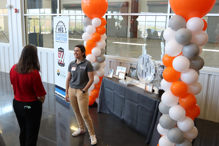 A UT student welcomes guests at the Machine Tool Research Center