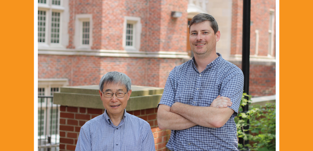 Materials science and engineering professors Peter Liaw and Eric Lass pose in front of Ferris Hall on a sunny afternoon.