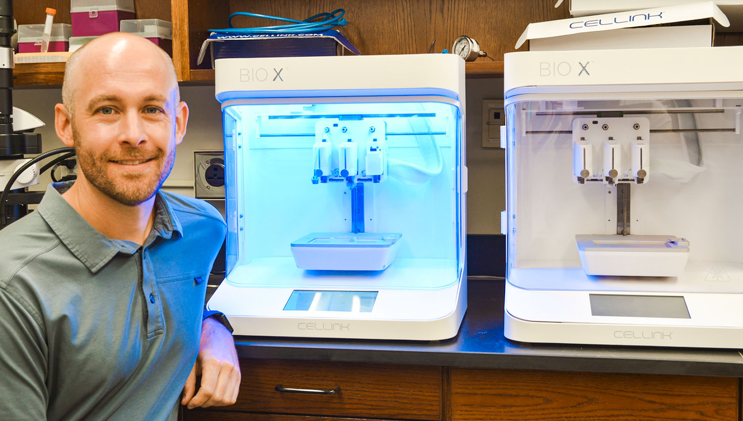 Andy Sarles with two bioprinters, which are used to make synthetic biomaterials like cell membranes.