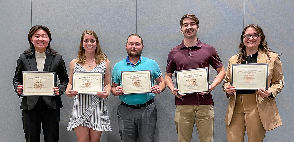Five students present their awards from the eureka research presentations.