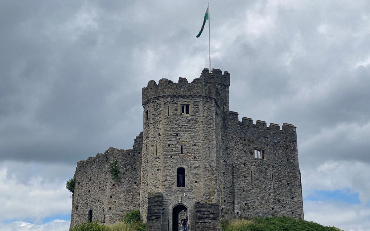 Cardiff Castle stands against a overcast sky background in Cardiff, Wales.