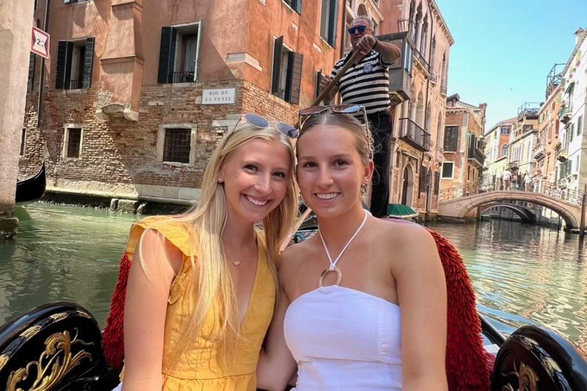 Madilyn Morelock and a colleague ride in a gondola boat through the canals of Venice.