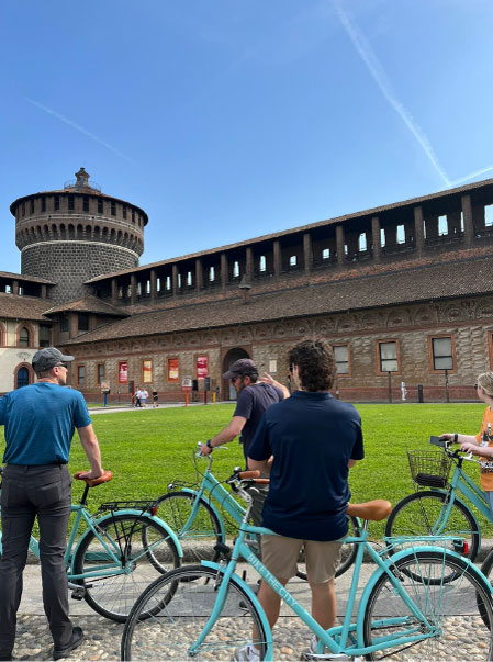 Milan study abroad students sit on bicycles that they used to tour the city.