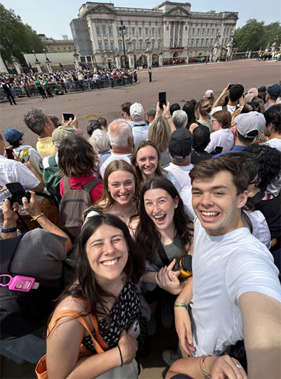 Frank Moser and other Engineering in London study abroad students stand together for a selfie in front of a historic area of London.