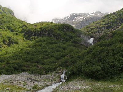 A scenic view of a creek running down the side of Mt. Titlus in Engelberg