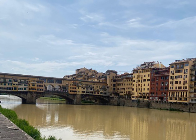 A scenic view of the canal and historic buildings in Florence, Italy.