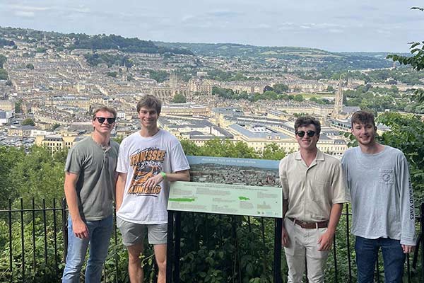 Nathan Lacognata and three other Engineering in London study abroad students stand together for a group photo in an elevated position that overlooks the city of London.