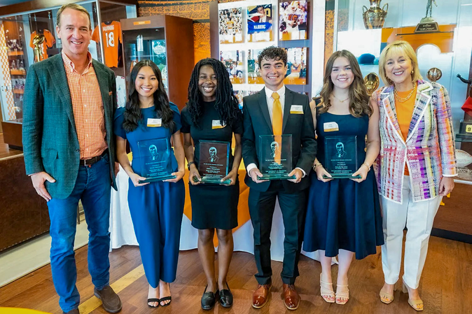 Peyton Manning and Chancellor Donde Plowman recognize the newest Peyton Manning Scholars. Pictured from left to right are Ellie Housley, Ariel Thompson, Coleman Bain and Ava Foley.
