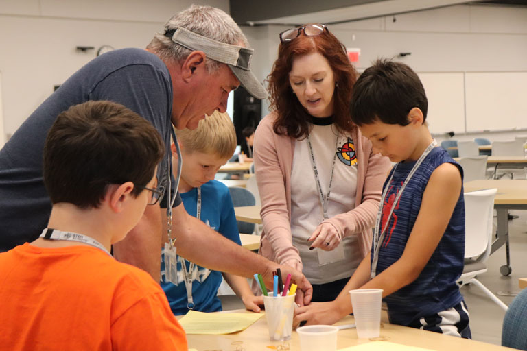 Audra Humbard works with young students during the STEM Summer Camp
