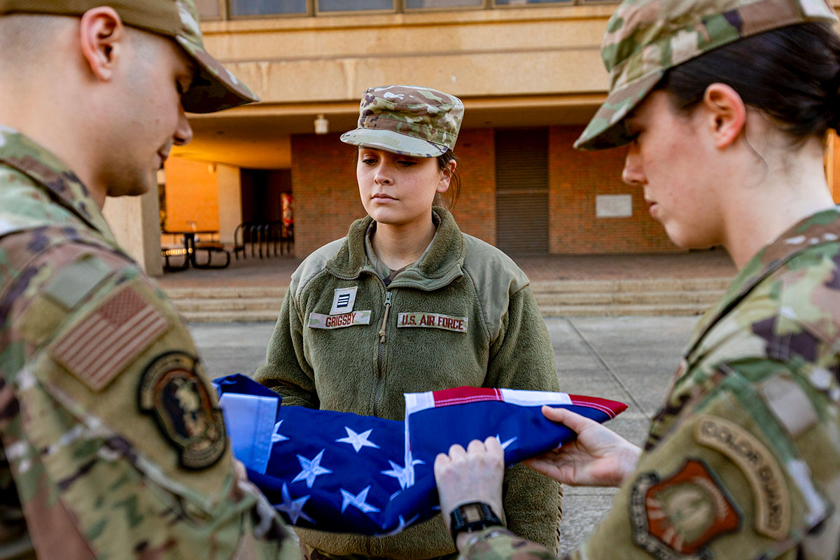 Air Force ROTC Cadet Sally Grigsby oversees cadets folding flag as part o ROTC drills. 