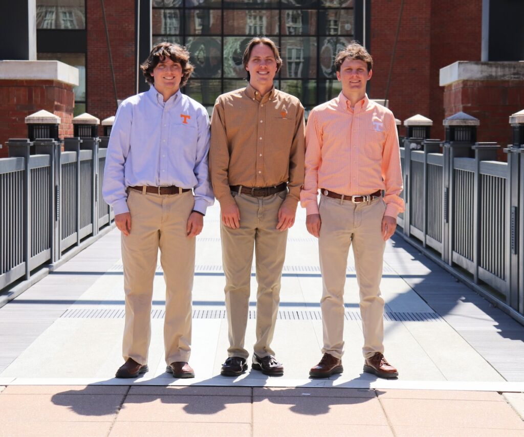 Walker, Jackson, and Grey Reeves standing outside the John D. Tickle Engineering Building