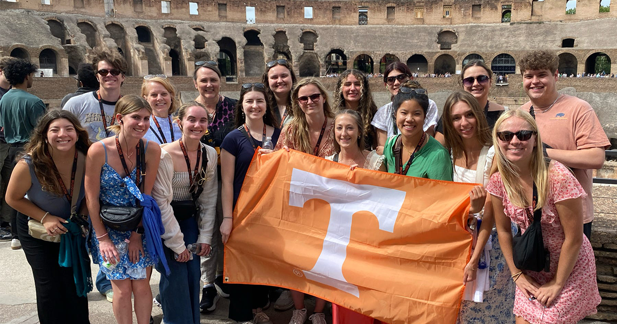 students studying abroad in Florence, Italy holding a University of Tennessee flag up