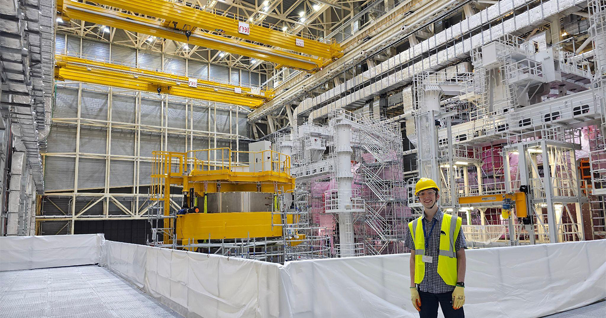 Daniel Metcalf standing in the middle of the world's largest fusion experiment in France
