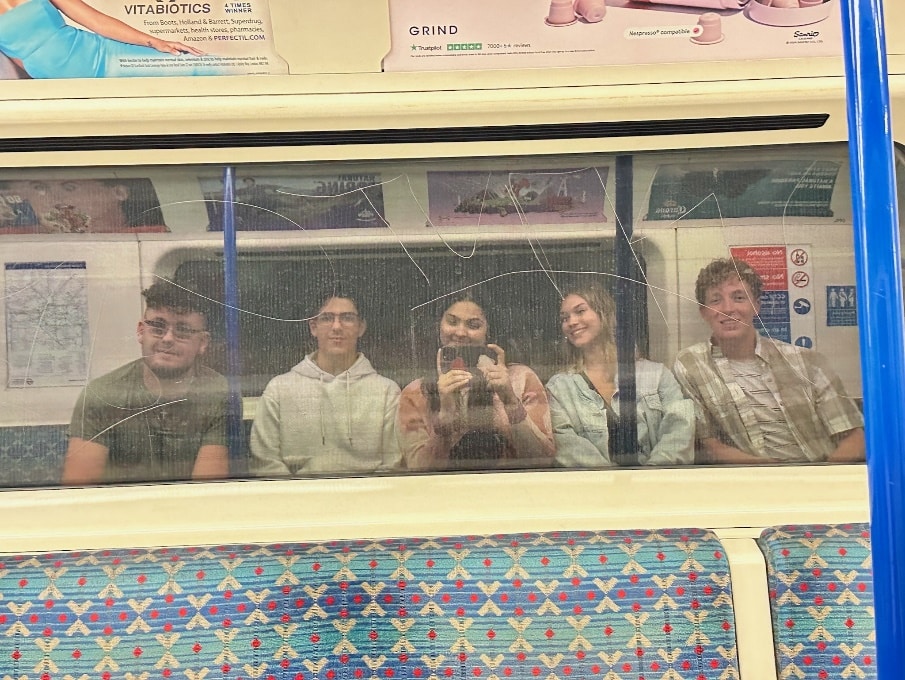 Jackson Moore and his friends riding the tube in London