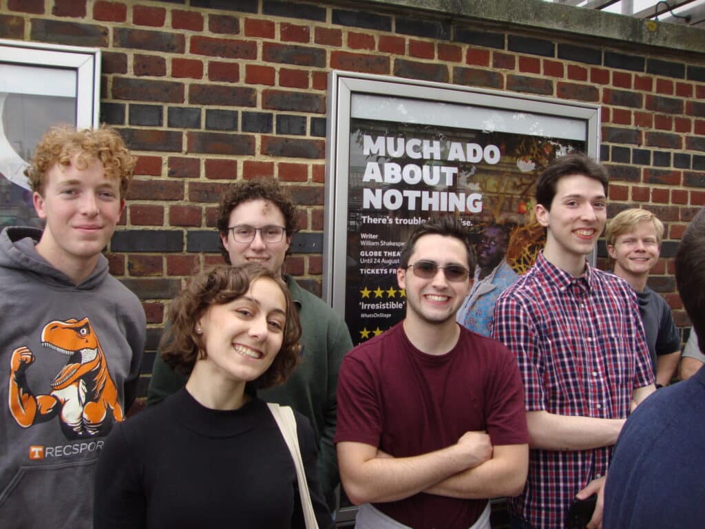 Engineering in London class standing in front of a theater marquee that reads "Much Ado About Nothing"