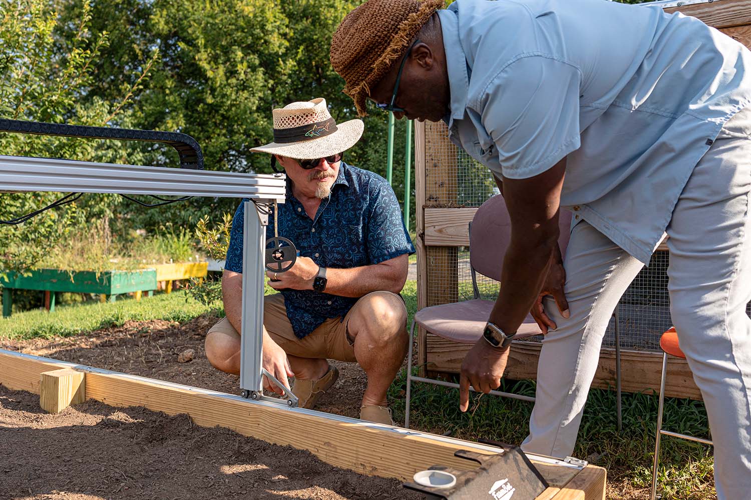 Community members look at the raised seed bed