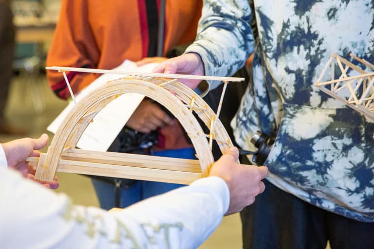 Students testing Balsa Wood Bridge Competition entry