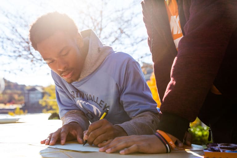 Student fills out form at Engineers Day