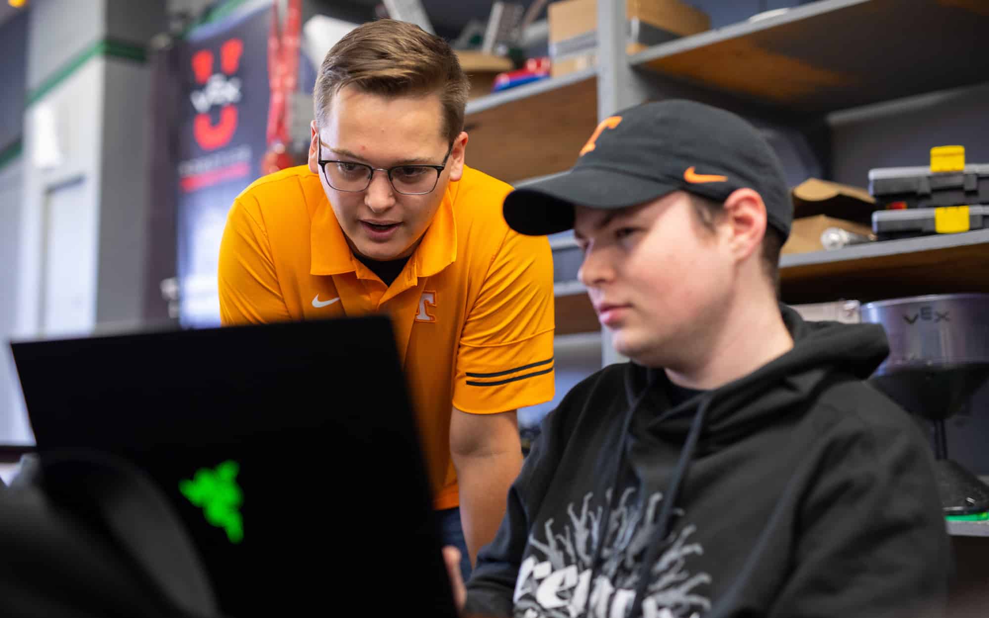 Grant Kobes and another student from the VexU Robotics team work on a computer. 