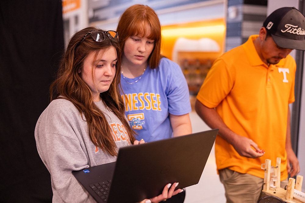 Two students work on computer while working on final project in an Engineering Fundamentals lab. 