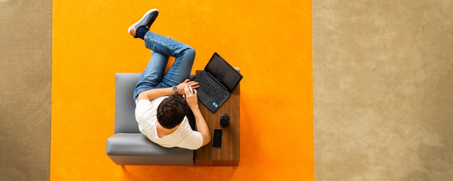 Student sitting in UC using laptop computer.