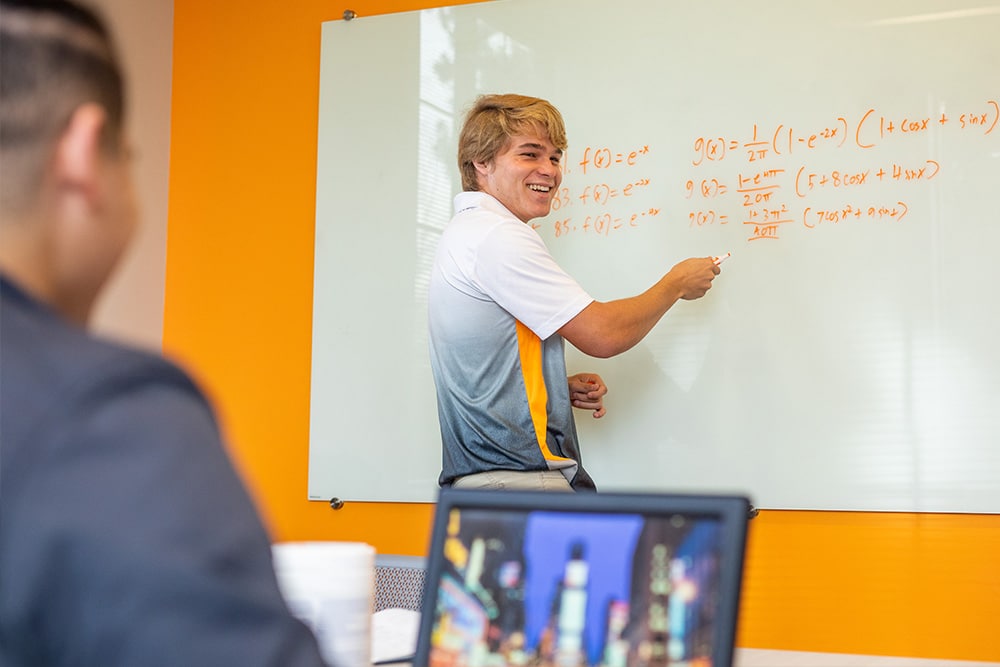 Student works on math problem in White Hall.