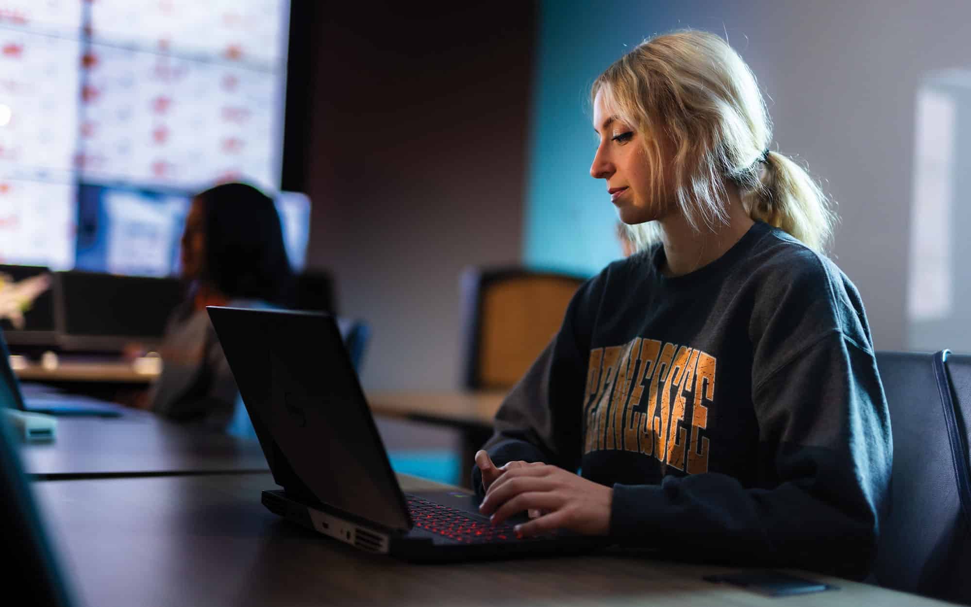 Undergrad students work on community engagement research in the Grid Control and Visualization Lab for the Center for Ultra-Wide-Area Resilient Electronic Energy Transmission Networks (CURENT) inside the Min H. Kao Electrical Engineering and Computer Science Building.