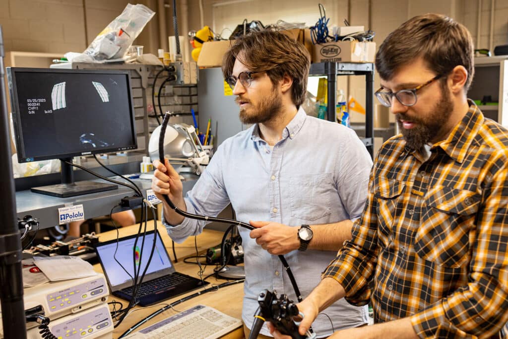 Grad student works with Caleb Rucker in Dougherty Engineering Lab