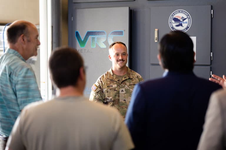 Army soldier presenting to faculty and staff