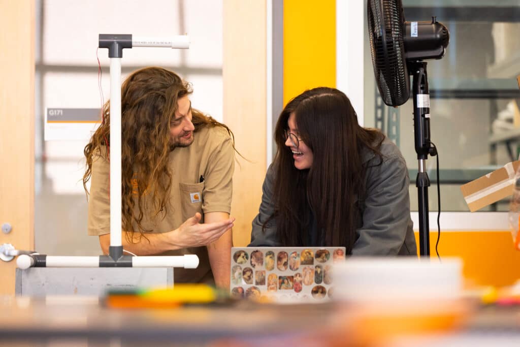 Engineering student and faculty work on wind turbine demonstration for Engineering Day at the Zeanah Engineering Complex
